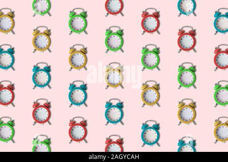 Small colorful alarm clocks without hands pattern minimal creative no time concept. Stock Photo
