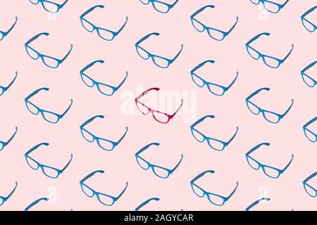 Pattern made of blue eyeglasses with one in pink color minimal creative diversity concept. Stock Photo