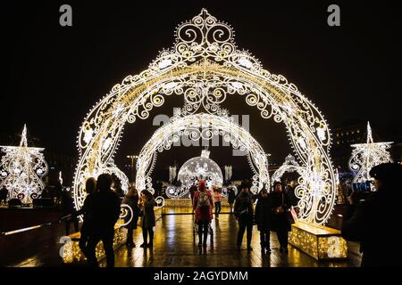 Moscow, Russia. 22nd Dec, 2019. People are seen by illuminated installations during the Journey to Christmas festival in central Moscow, Russia, on Dec. 22, 2019. From Dec. 13, 2019 to Jan. 12, 2020, illuminated installations decorate the holiday season among streets and squares in Moscow. Credit: Maxim Chernavsky/Xinhua/Alamy Live News Stock Photo