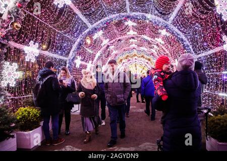 Moscow, Russia. 22nd Dec, 2019. People walk through illuminated installations during the Journey to Christmas festival in central Moscow, Russia, on Dec. 22, 2019. From Dec. 13, 2019 to Jan. 12, 2020, illuminated installations decorate the holiday season among streets and squares in Moscow. Credit: Maxim Chernavsky/Xinhua/Alamy Live News Stock Photo