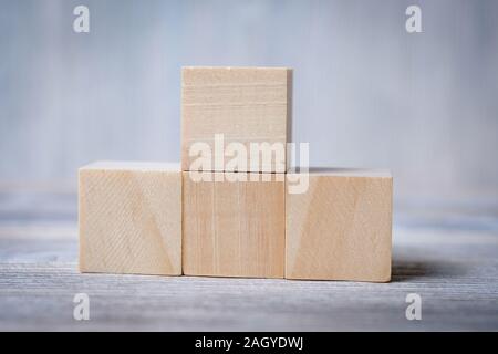 Wooden cubes against a grey background. Mock up. Close up. Stock Photo