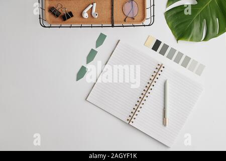 Flat layout with open notebook with blank pages, palette and other office stuff Stock Photo
