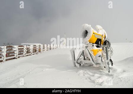 Snow gun machine waiting for frost with sun flare background, snowmaker  machine. Color effect Stock Photo - Alamy