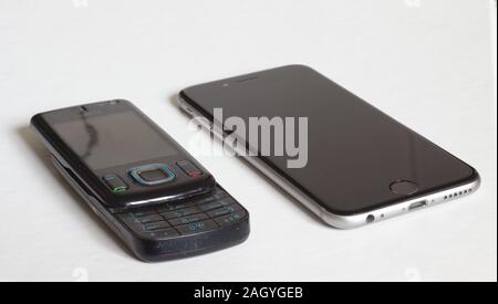 Bern, Switzerland, dezember, 2019: Old nokia phone next to newer iphone 7 on white background. Stock Photo