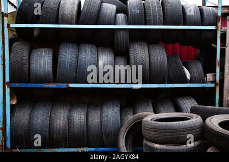 Tire stack background. Pile of old tires neatly arranged. Stock Photo