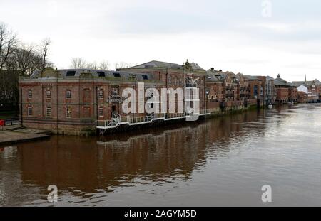 Buildings line the banks of the flooding river Ouse in York, UK Stock Photo