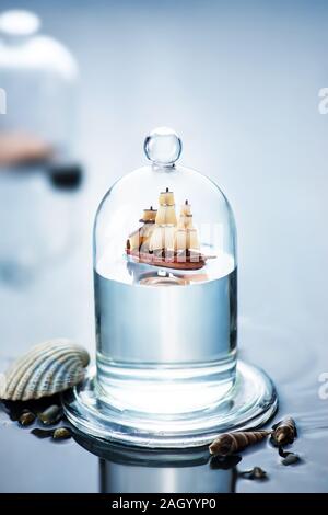 Sailboat under a glass dome, ship in the bottle concept with copy space Stock Photo
