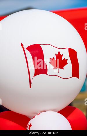 Red and white balloons decorated with maple leaf and Canadian flag, symbolic of Canada Day celebrated every July 1 Stock Photo