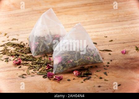 Two bags of cranberry green tea tea on the board Stock Photo