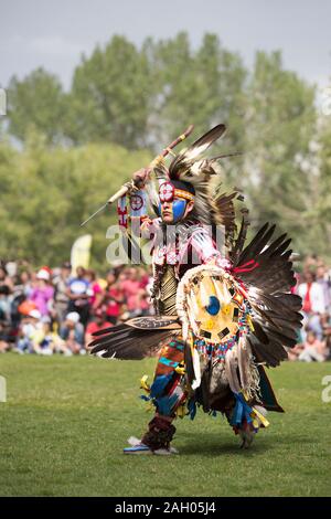Native American powwow dancer in full traditional regalia at dusk ...
