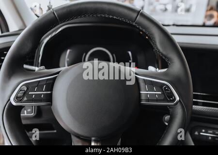 Steering Wheel and Dashboard of the Car in black. Stock Photo