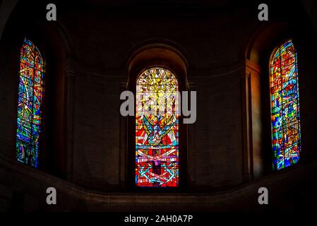 BELFAST, NORTHERN IRELAND, DECEMBER 19, 2018 Detail of three colorful stained glass windows from inside of church, reflecting colors in its walls. Stock Photo