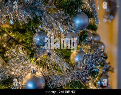 Selective focus and close up of silver baubles on a Christmas tree Stock Photo