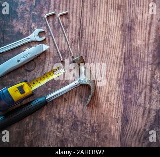 Top down view of various DIY tools on a wooden background Stock Photo