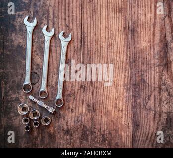 Top down view of spanners and sockets on a plain wooden background with copy space Stock Photo
