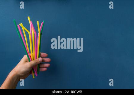 plastic straws in a hand Stock Photo