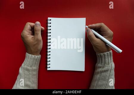 Close up of man hand holding white blank spiral notebook Stock Photo