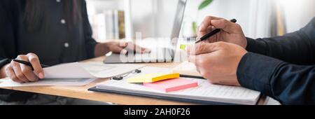 Young students classmates help friend catching up workbook and learning tutoring in a library, education and school concept. Stock Photo