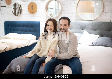 Happy couple having good time in furniture salon Stock Photo