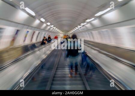 Subway passengers on escalators. Motion blur. Stock Photo