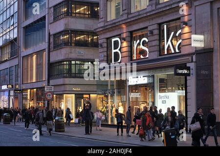 LONDON, UK - APRIL 23, 2016: People shop at Bershka and Zara, Oxford Street in London. Oxford Street has approximately half a million daily visitors a Stock Photo