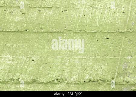 Green grunge wall texture. Rough grungy background. Caper green shade. Stock Photo