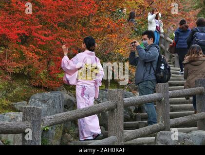 KYOTO, JAPAN - NOVEMBER 25, 2016: Visitors enjoy autumn at Tenryuji gardens in Arashiyama, Kyoto, Japan. Kyoto has 17 UNESCO World Heritage Site landm Stock Photo