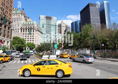 NEW YORK, USA - JULY 4, 2013: People ride yellow taxi in Lower Manhattan in New York. As of 2012 there were 13,237 yellow taxi cabs registered in New Stock Photo