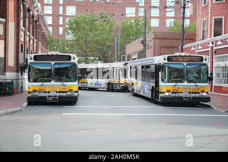 CAMBRIDGE, USA - JUNE 9, 2013: Boston city buses (MBTA Bus) in Cambridge, MA. MBTA Bus operates on 177 lines. Stock Photo