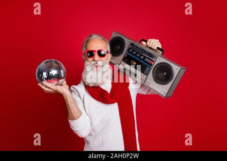 Portrait of his he nice cool handsome cheerful glad positive gray-haired man in pullover sweater having fun celebratory occasion nightclub disco Stock Photo