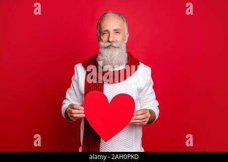 Close-up portrait of his he nice attractive confident peaceful gray-haired man holding in hands heart health care medicine cardiology isolated over Stock Photo
