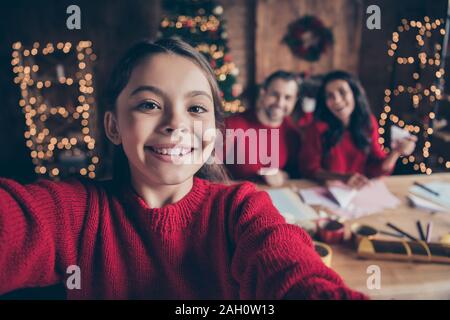 Self portrait of photographing shooting cozy comfort cheerful kind happy child people handmade wearing red pullover who tried to shoot her parents mom Stock Photo