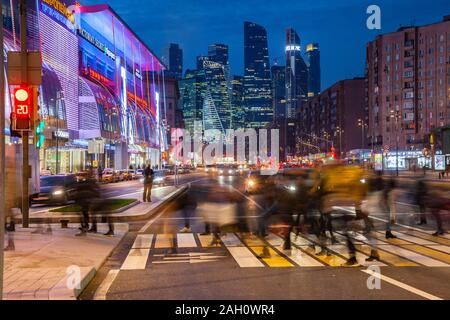 Moscow, Russia - November 15, 2018: Crowd of people crossing the Kutuzovsky Avenue with the Moscow City skyscrapers seen on the background on November Stock Photo