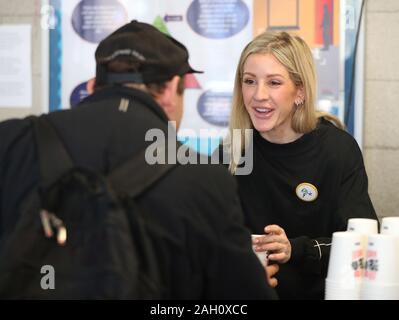 Ellie Goulding serves coffee to a guest while volunteering at a Crisis Christmas centre in London, as the charity opens its doors to homeless people for the festive period. Stock Photo