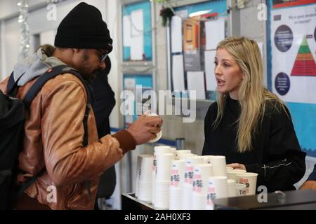 Ellie Goulding serves coffee to a guest while volunteering at a Crisis Christmas centre in London, as the charity opens its doors to homeless people for the festive period. Stock Photo