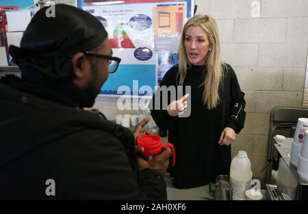 Ellie Goulding serves coffee to a guest while volunteering at a Crisis Christmas centre in London, as the charity opens its doors to homeless people for the festive period. Stock Photo