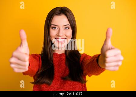POrtrait of positive cheerful lady show double thumb up give her feedback about excellent sales discounts wear red sweater isolated over yellow color Stock Photo