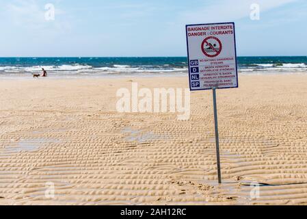 warning sign on beach with dangerous currents where swimming is not allowed Stock Photo