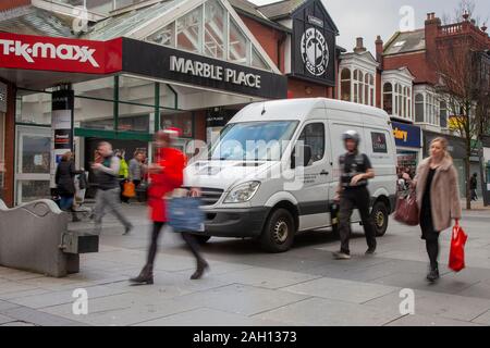 Loomis Van & security guard making delvery; Christmas in Chapel Street, Southport, UK Stock Photo