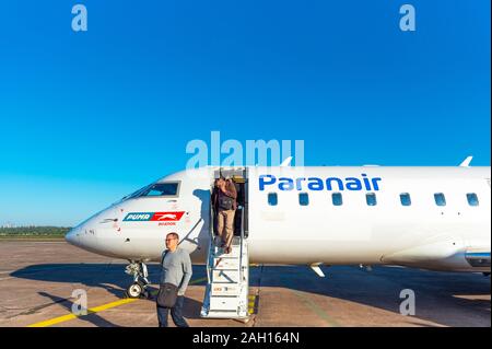 ASUNCION, PARAGUAY - JUNE 24, 2019: Men get off the plane at the airport. Copy space for text Stock Photo