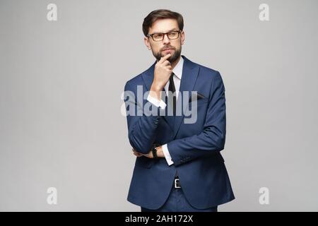 Studuo shot of thinking businessman wearing suit Stock Photo