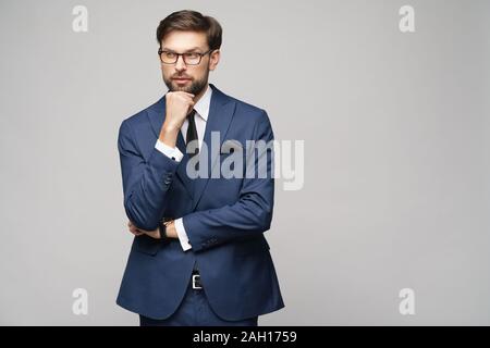 Studuo shot of thinking businessman wearing suit Stock Photo