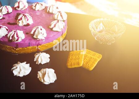 Blueberry cake with biscuits and cookies on the black table Stock Photo