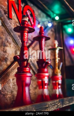 three hookahs on the shelf under the inscription not to smoke Stock Photo