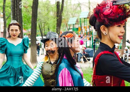 BISHKEK, KYRGYZ REPUBLIC - APRIL 14, 2018: Have fun in Masquerade party with clowns and beautiful women Stock Photo
