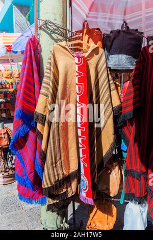 ASUNCION, PARAGUAY - JUNE 24, 2019: Selling poncho in the local market. Vertical Stock Photo