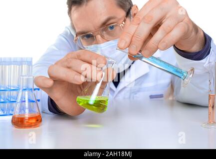 Male researcher carrying out scientific research in a lab. Close up. Focus on hands. Stock Photo