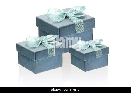 Three gift gray with a greenish tinge boxes isolate on a white background, close-up, reflection. Stock Photo