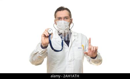 Close-up photo of male doctor in mask using stethoscope and keeps finger point up. Isolated on white. Healthcare concept. Stock Photo