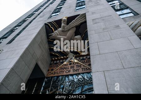 New York City - USA - DEC 17 2018: Underside perspective view to exterior Art Deco details of Rockefeller Center building in midtown Manhattan Stock Photo